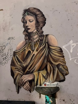 Street art in Kazimierz, Krakow. Elegant woman on crumbling wall.
